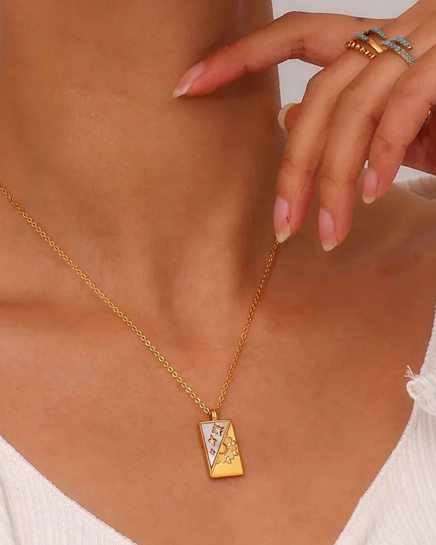 model wearing gold shadow and light tarot card necklace