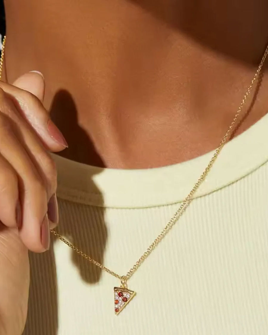 model wearing gold pizza slice shaped necklace