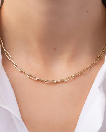 model wearing gold paperclip link necklace