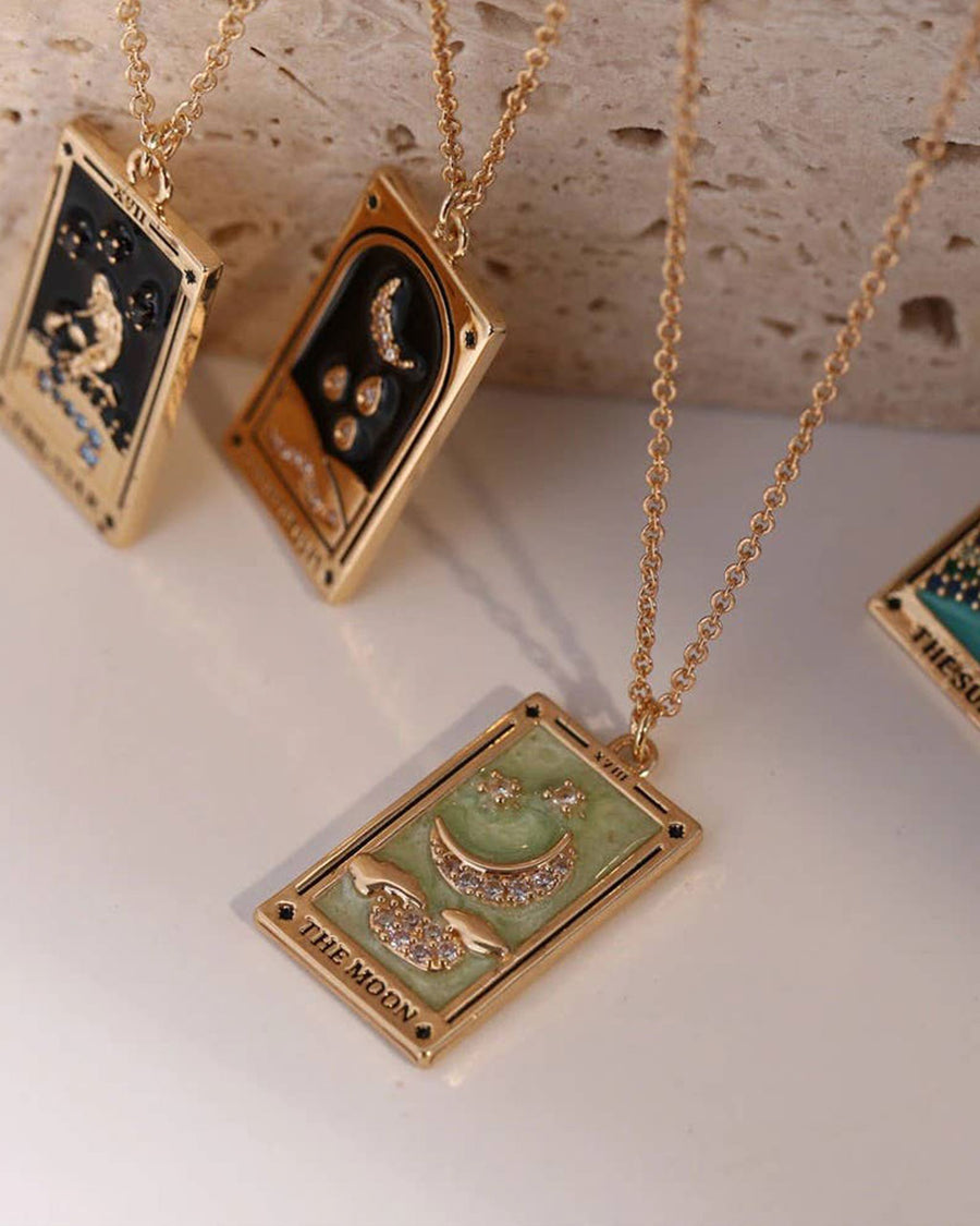 up close of gold 'the moon' tarot card necklace