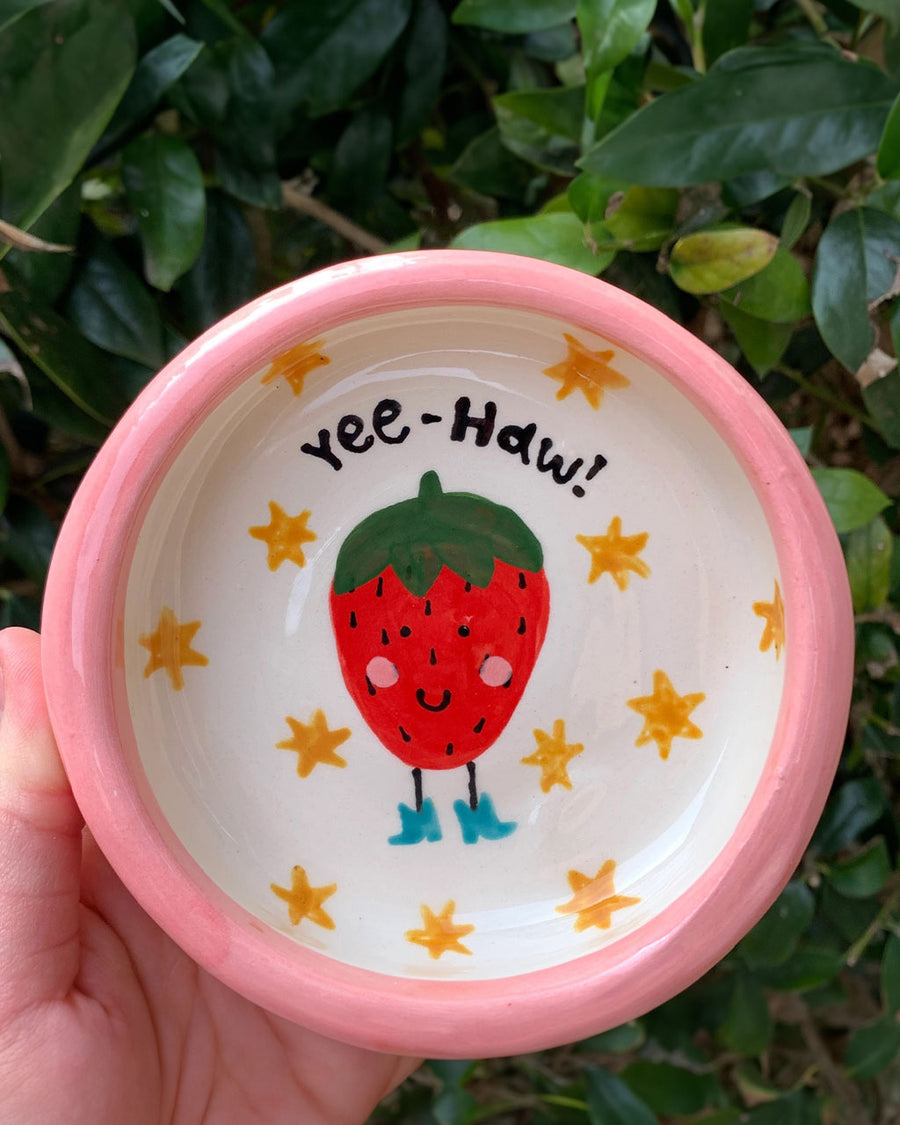 handmade trinket tray with pink trim and yee-haw strawberry in the center