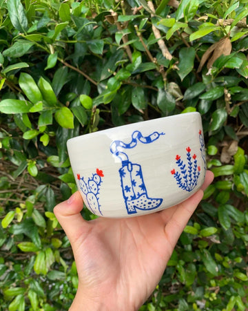 white ceramic planter with blue and red western desert scene
