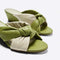 up close of olive green and cream twist wedge sandals