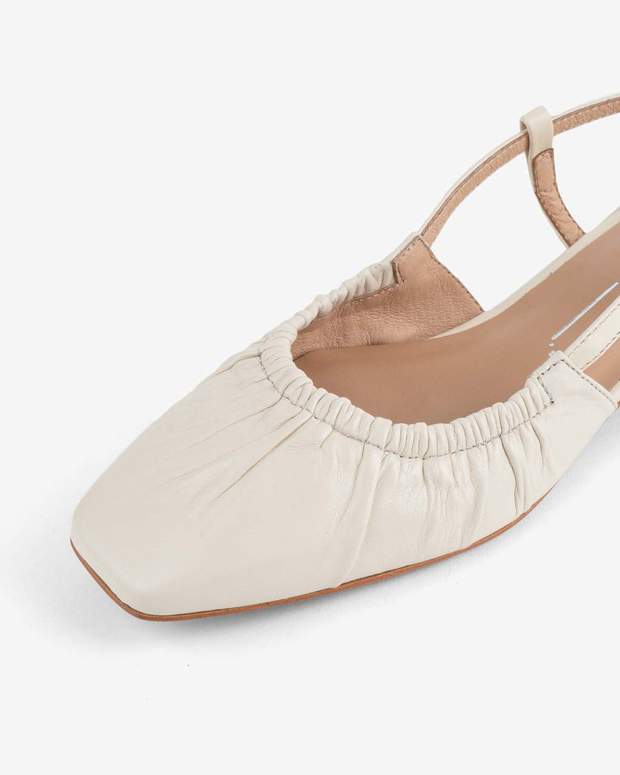 up close of front of cream slingback shoe with scrunched front and strappy back