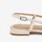 back view of buckle on cream slingback shoe with scrunched front and strappy back