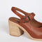 back view of dark brown square toed clog with buckle and back strap