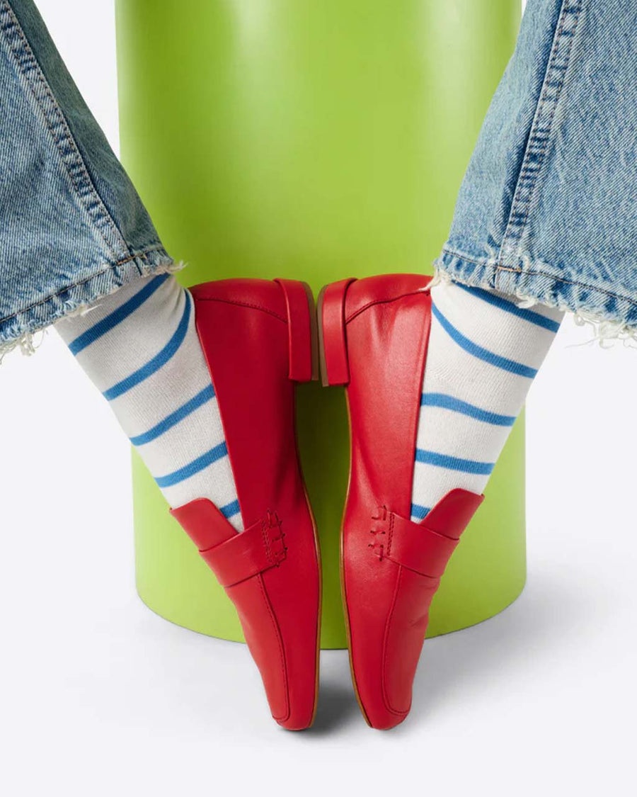 model wearing cherry red leather loafer shoe