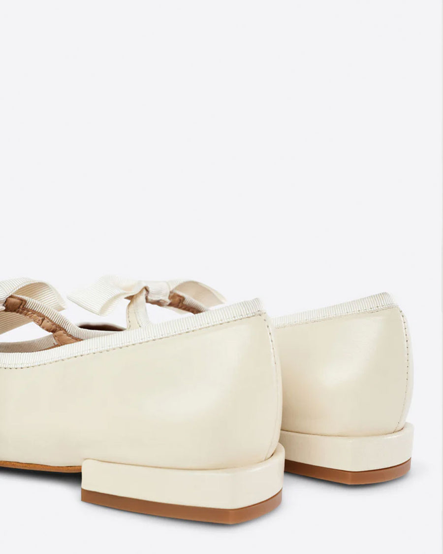 back view of creme mary jane shoes with bow strap