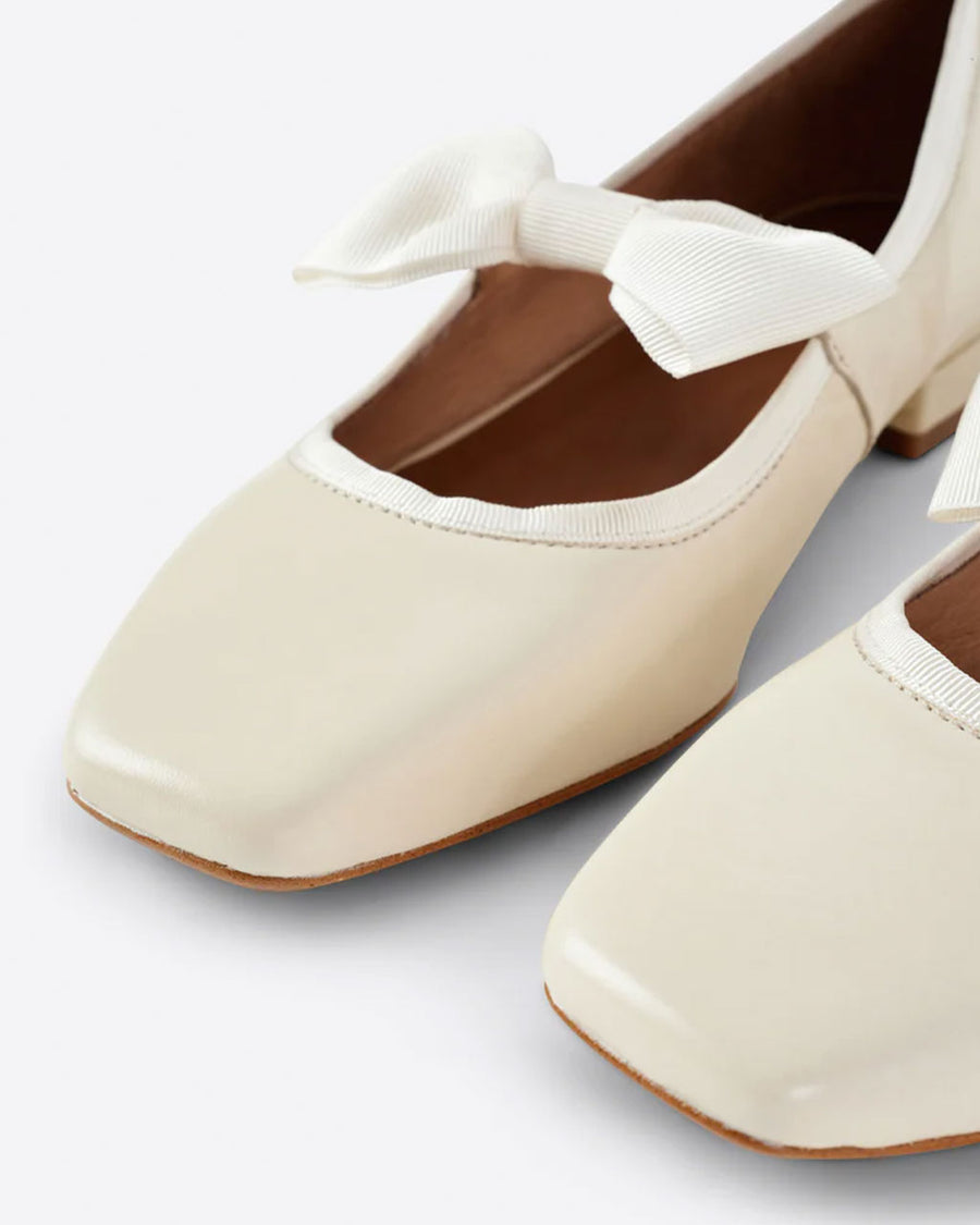 up close of creme mary jane shoes with bow strap