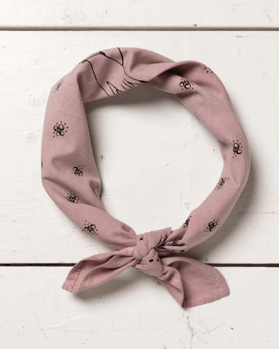 tied mauve square bandana with dainty hand holding a flower and all over dainty print