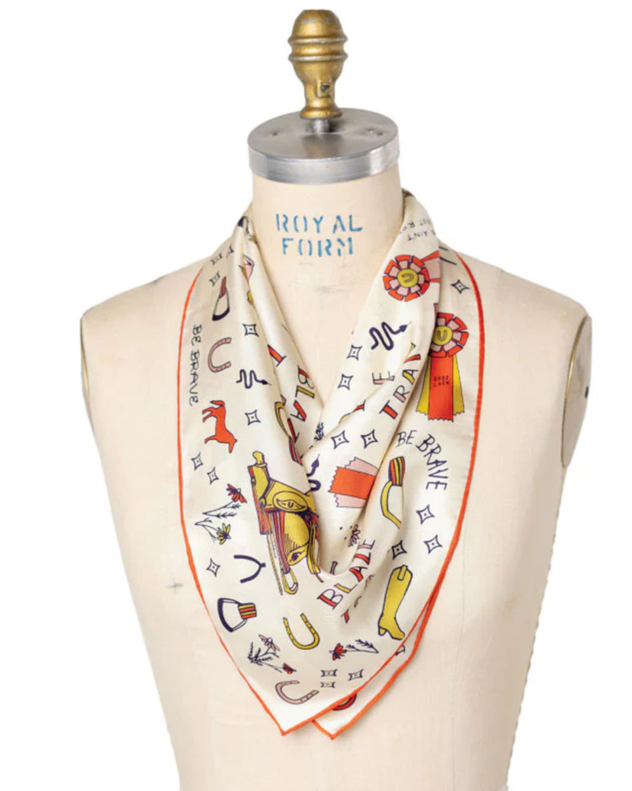 folded white silk square bandana with colorful horse print with cute sayings all over on a mannequin