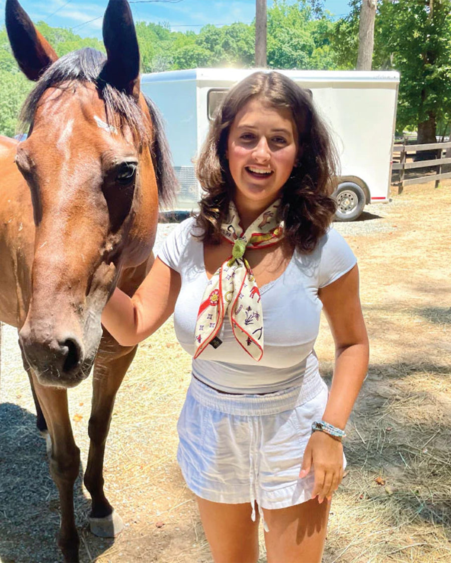 model wearing white silk square bandana with colorful horse print with cute sayings all over