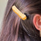 model wearing yellow crinkle french fry hair clip