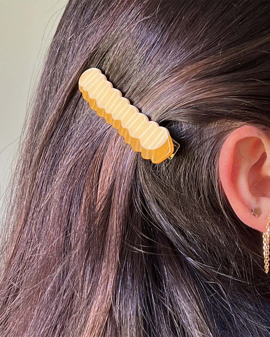 model wearing yellow crinkle french fry hair clip