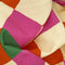 up close of pink, orange, yellow and green diamond tea towel