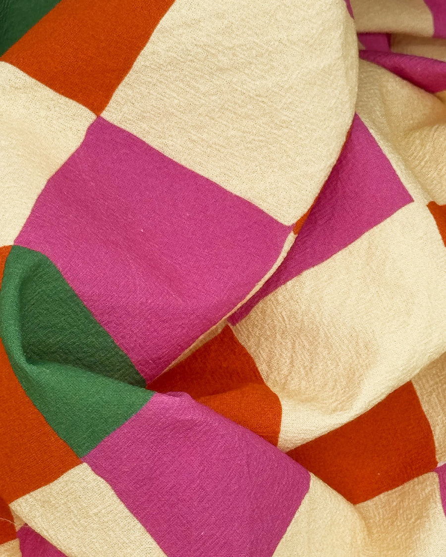 up close of pink, orange, yellow and green diamond tea towel