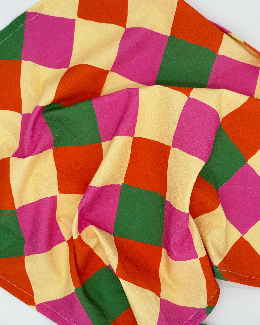 up close of pink, orange, yellow and green diamond tea towel