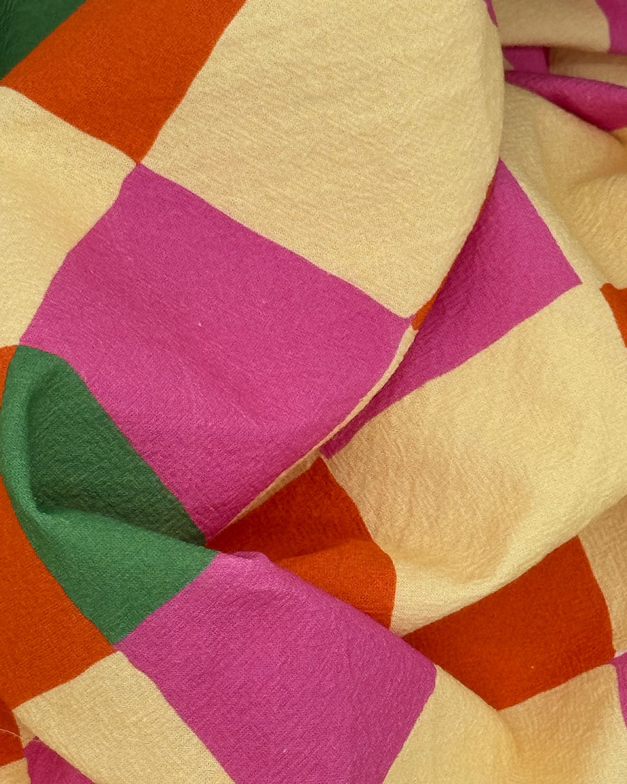 real up close of pink, orange, yellow and green diamond tea towel