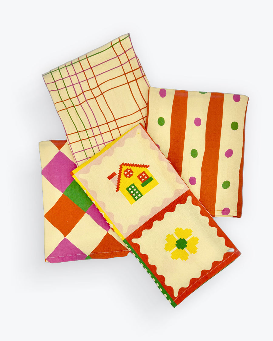 set of four ban.do x julie peach tea towels in plaid, stripes, diamond, and quilt