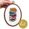 model holding stacked books embroidered cross stitch kit