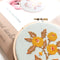 light blue embroidered cross stitch kit  with yellow flowers and box