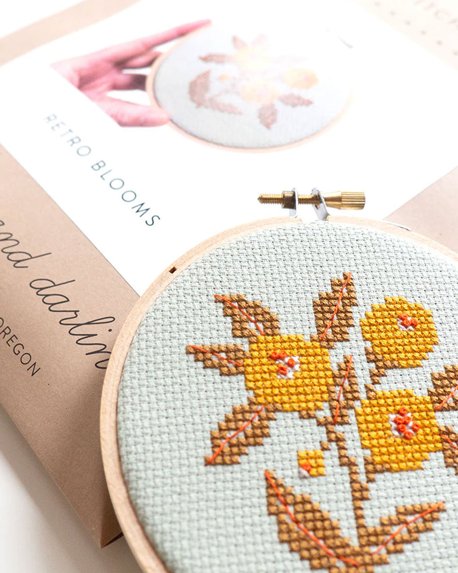 light blue embroidered cross stitch kit  with yellow flowers and box