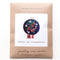 packaged navy blue embroidered cross stitch kit with strawberry and white floral print