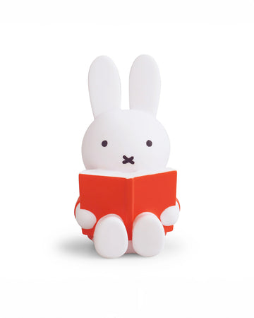 medium miffy sitting and reading a red book