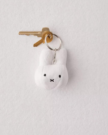 white muffy head plush keychain with keys on it