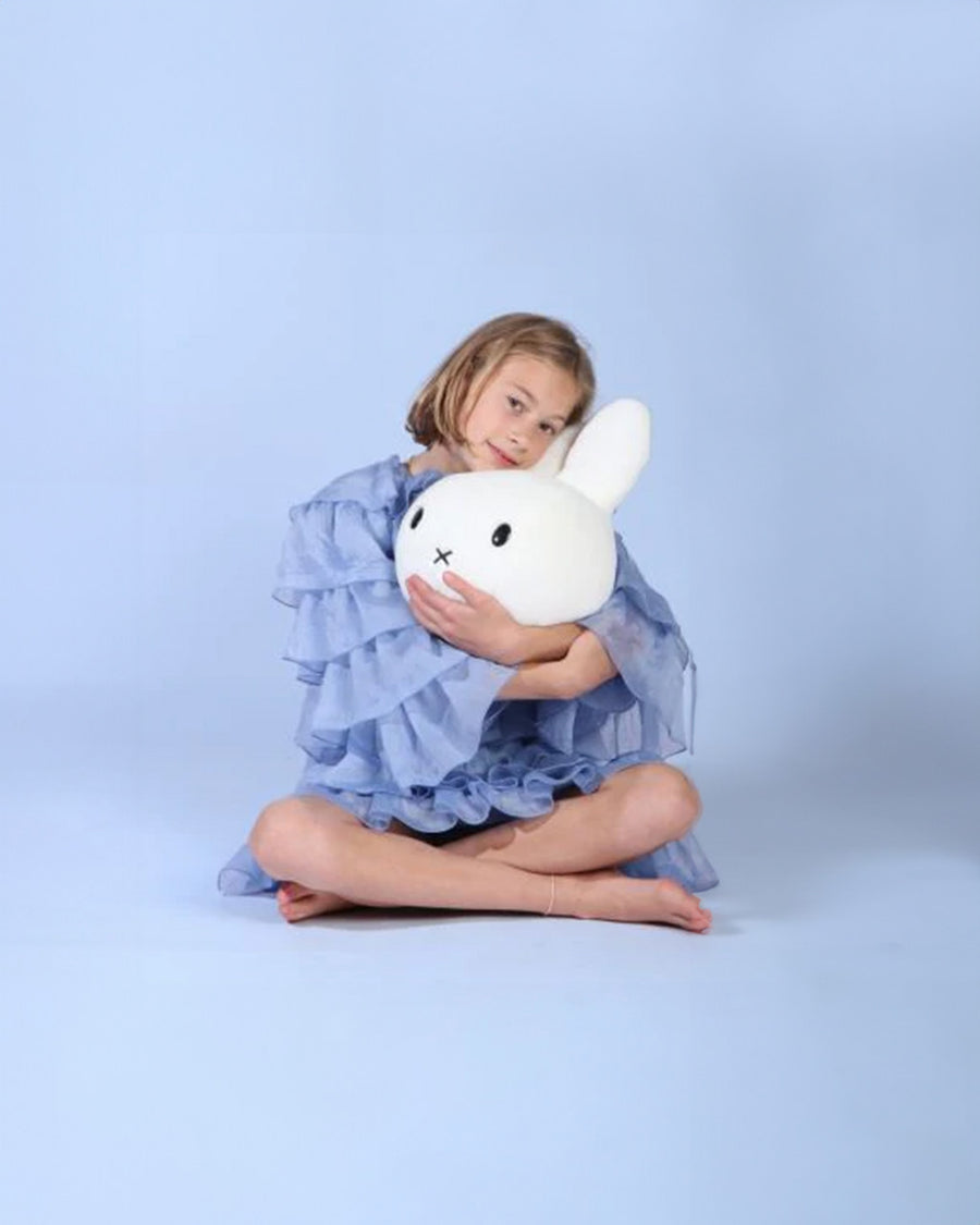 model holding white miffy plush/wall decor