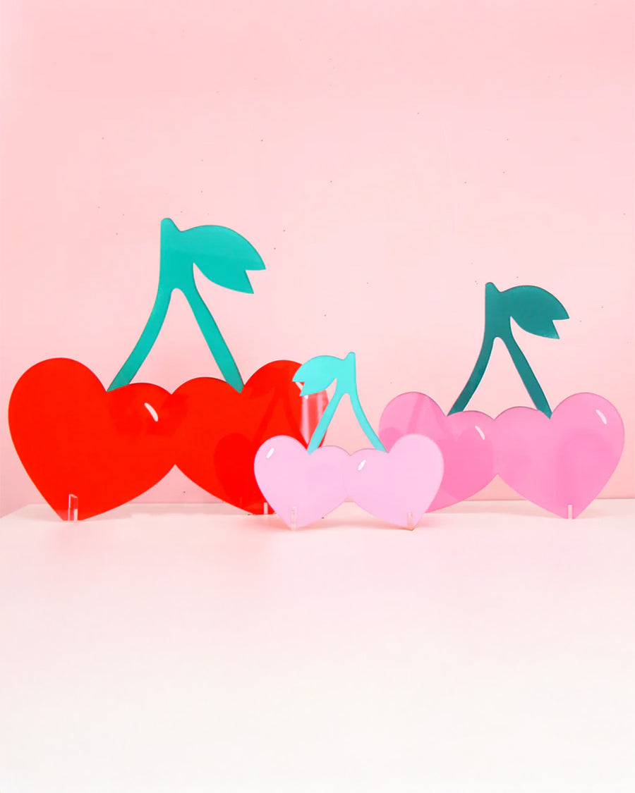 set of three cherry shaped decor with stands: large red cherries, medium pink cherries, and small light pink cherries