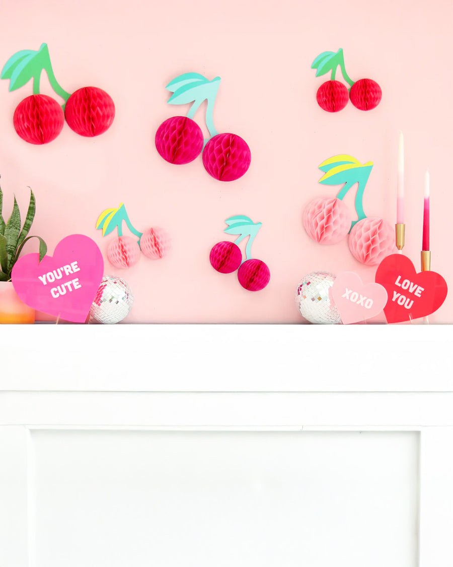 set of three acrylic conversation hearts on a fireplace