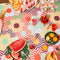 medium foldable picnic mat with colorful patchwork print with picnic items in it