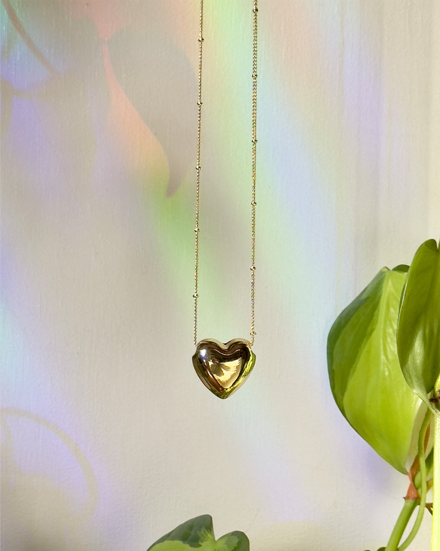 up close of gold heart shaped pendant necklace