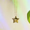 up close of gold star shaped pendant necklace