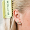 model wearing pair of stick of butter enamel earrings