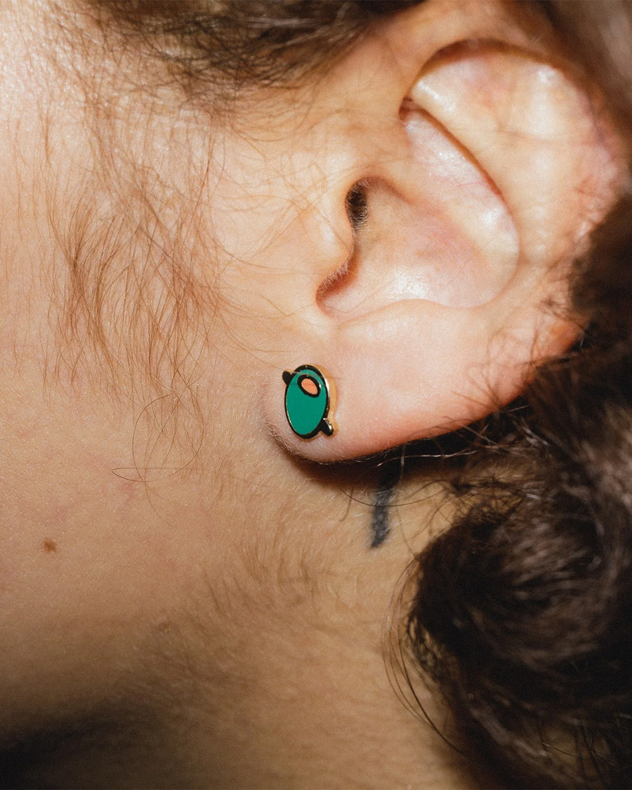 model wearing pair of green olive enamel earrings