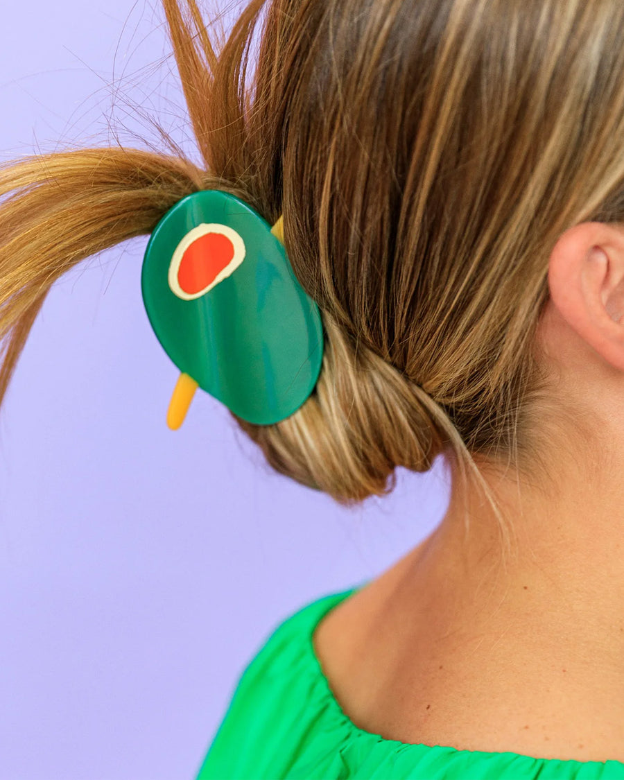 model wearing green olive with toothpick hair claw