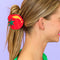 model wearing tomato shaped hair claw