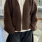 model wearing dark brown chunky knit open front cardigan with front patch pockets