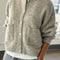 model wearing light grey cardigan with white button front and front patch pockets