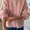 model wearing pink rose cardigan with white button front and front patch pockets