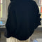 back view of model wearing black fuzzy quarter zip pullover