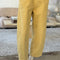 model wearing butter colored cotton canvas barrel pants with side inlets