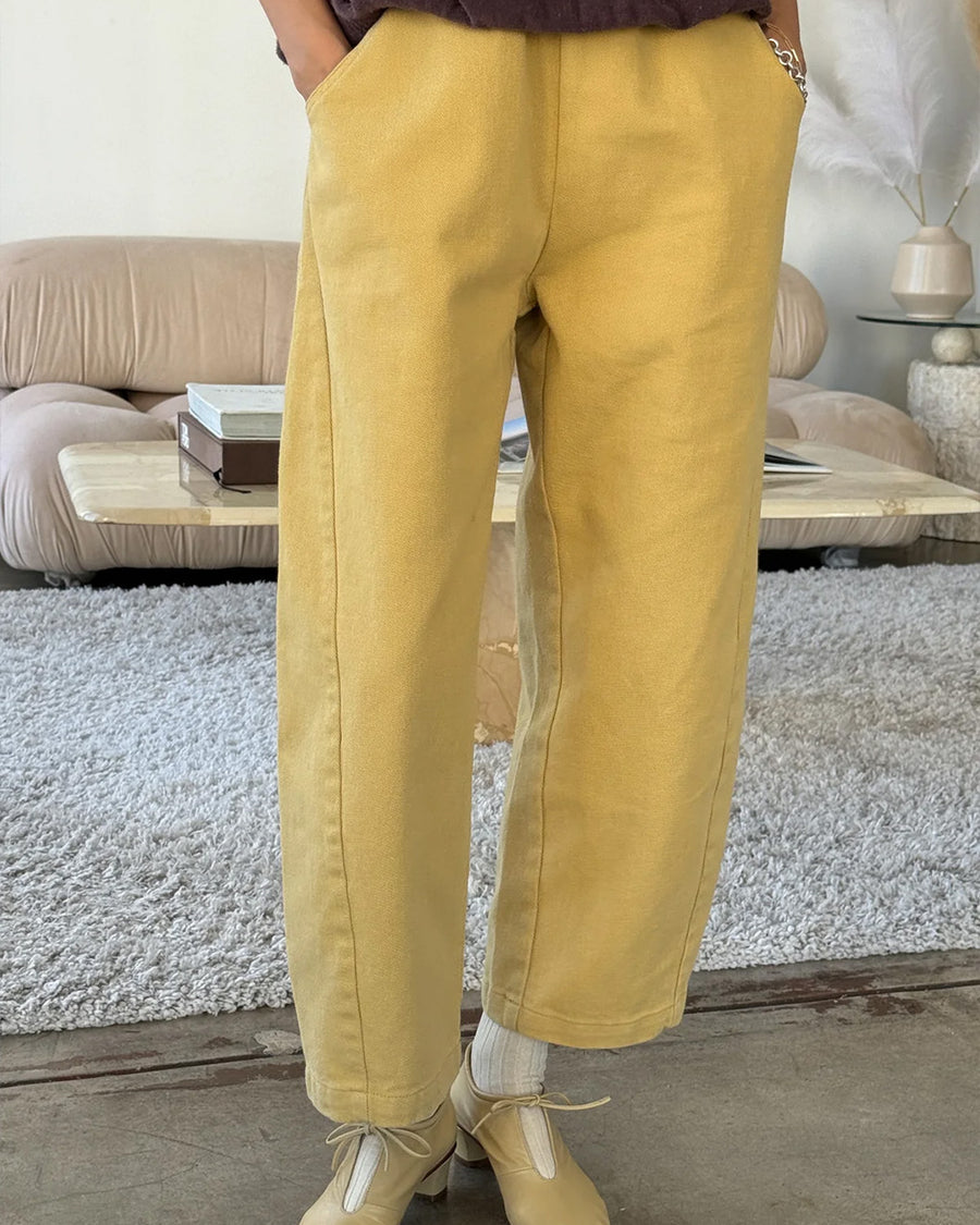 model wearing butter colored cotton canvas barrel pants with side inlets