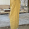 side view of model wearing butter colored cotton canvas barrel pants with side inlets