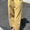 model wearing butter colored cotton canvas barrel pants with side inlets