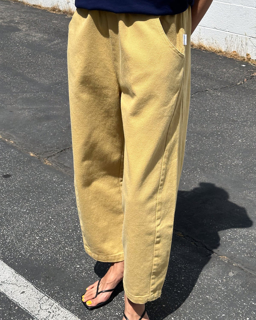 model wearing butter colored cotton canvas barrel pants with side inlets