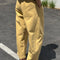 back view of model wearing butter colored cotton canvas barrel pants with side inlets