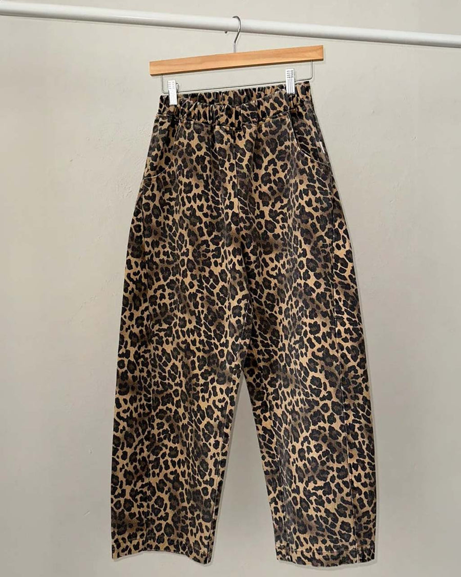 brown leopard print arc pants on a hanger